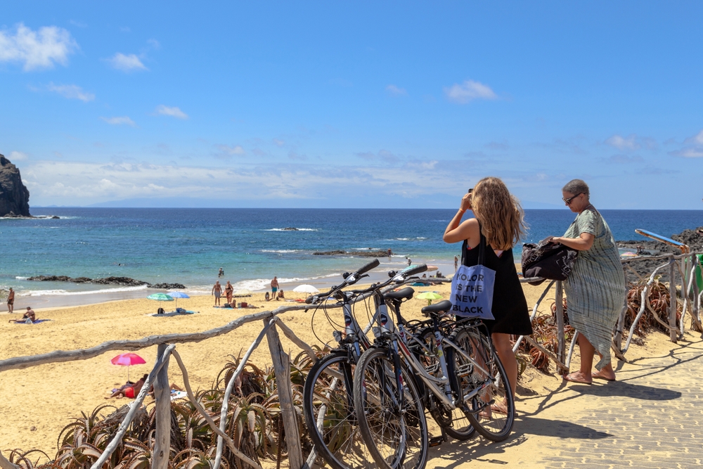 Rowery przy zejściu na plażę Porto Santo, na horyzoncie zarys Madery