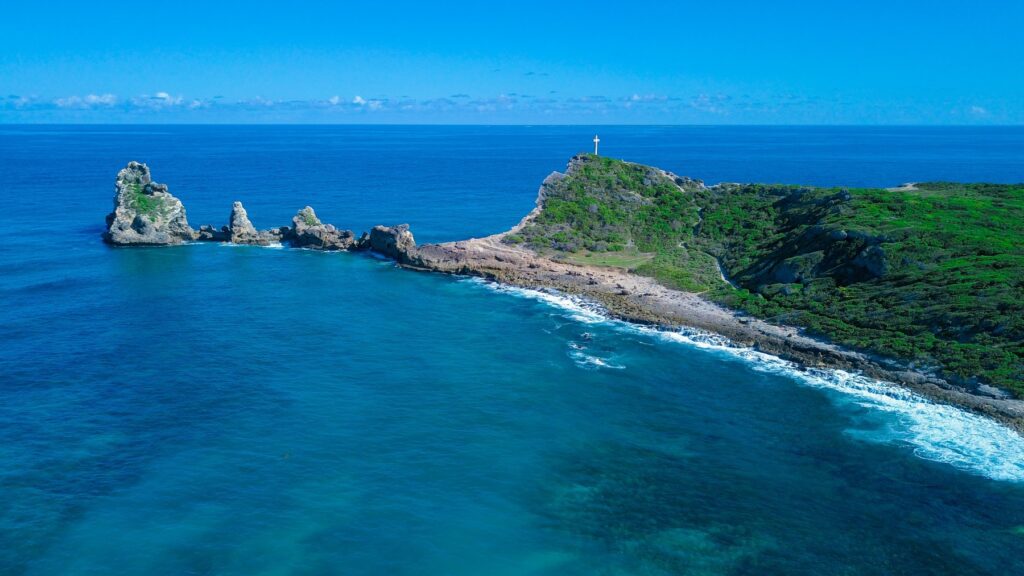 Pointe des Châteaux z lotu ptaka: skaliste iglice w oceanie i wzgórze z krzyżem na wschodnim krańcu Gwadelupy